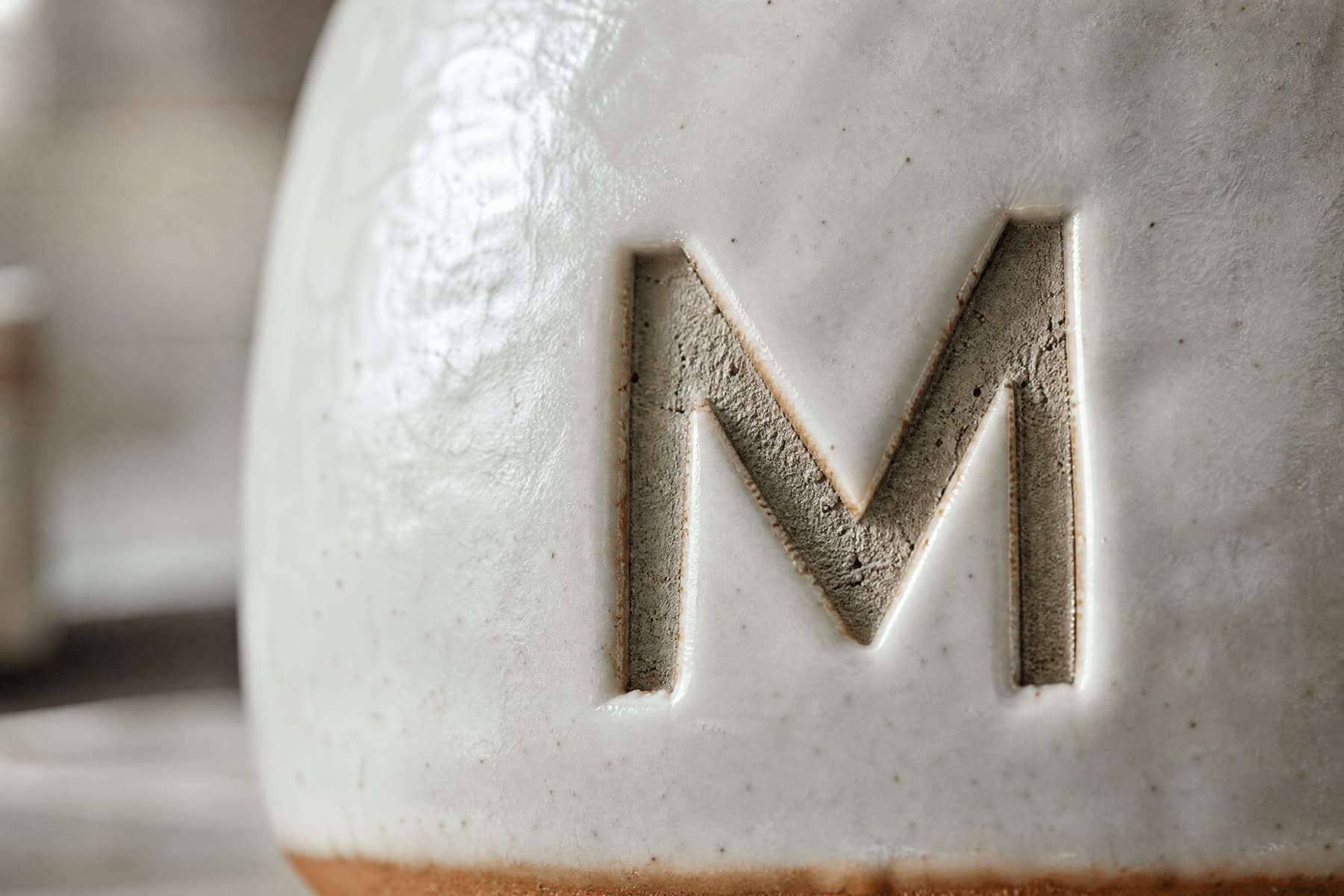 Macro view of a mark made by laser etch on white porcelain