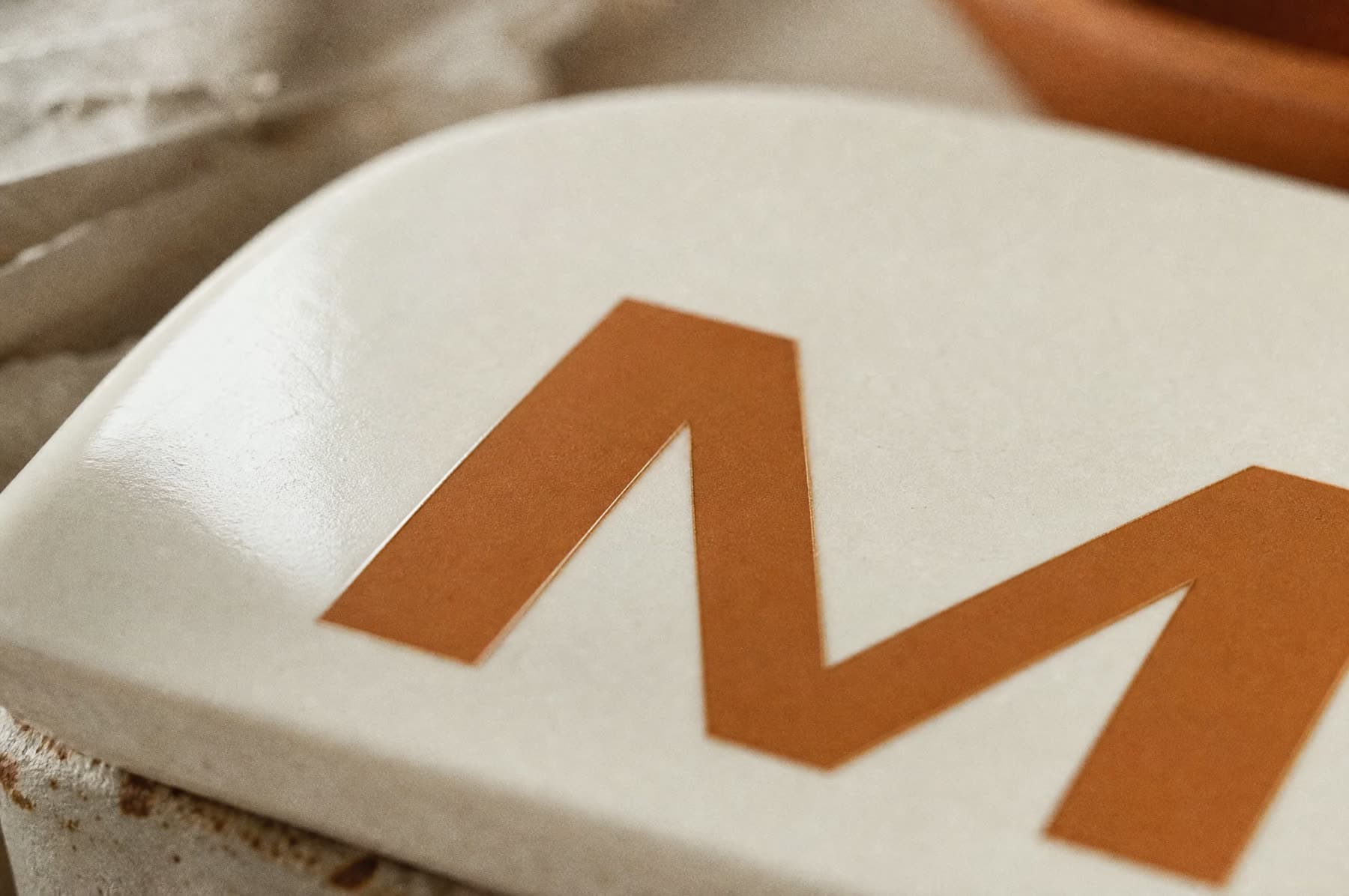 Macro view of a mark made by on-glaze decal on white porcelain