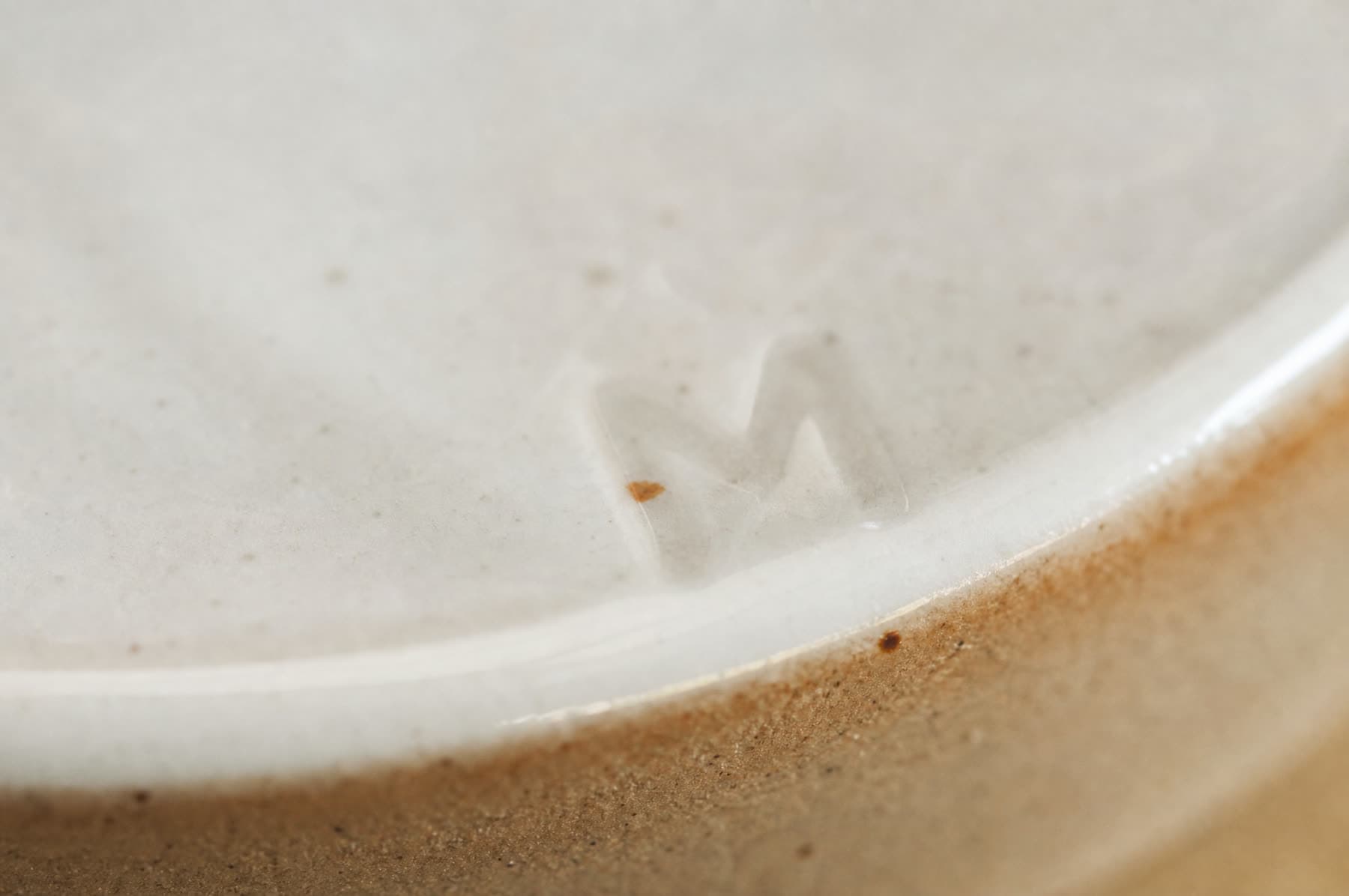 Macro view of a mark made by under-glaze on white porcelain
